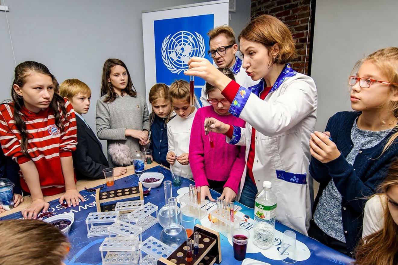 A teacher condunducting an all-female science class.