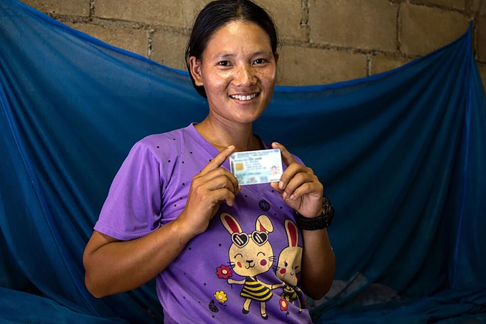 A former stateless woman shows her Thai identity card.