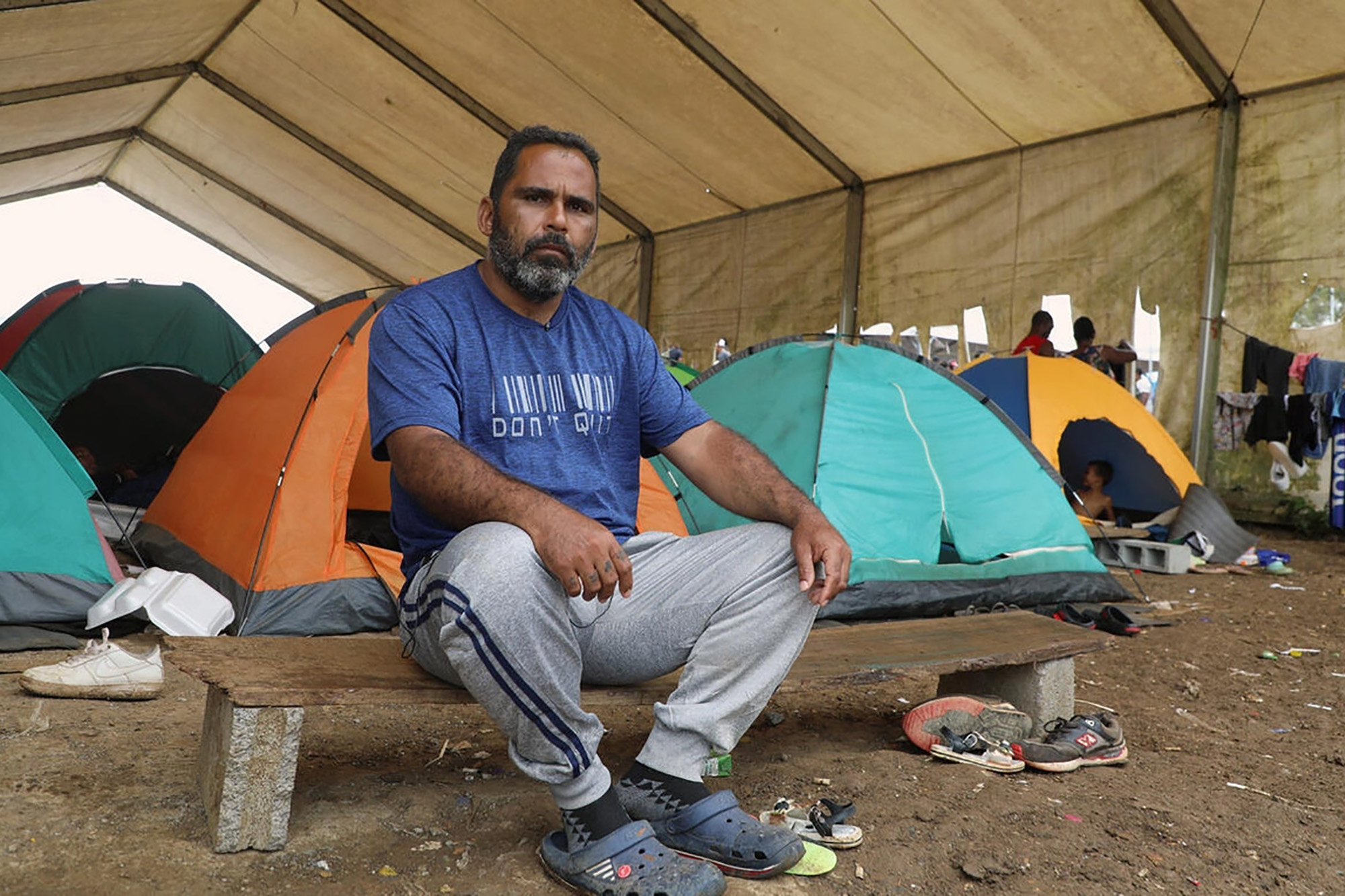 A man resting at a reception center in Panama after crossing the Darién jungle.