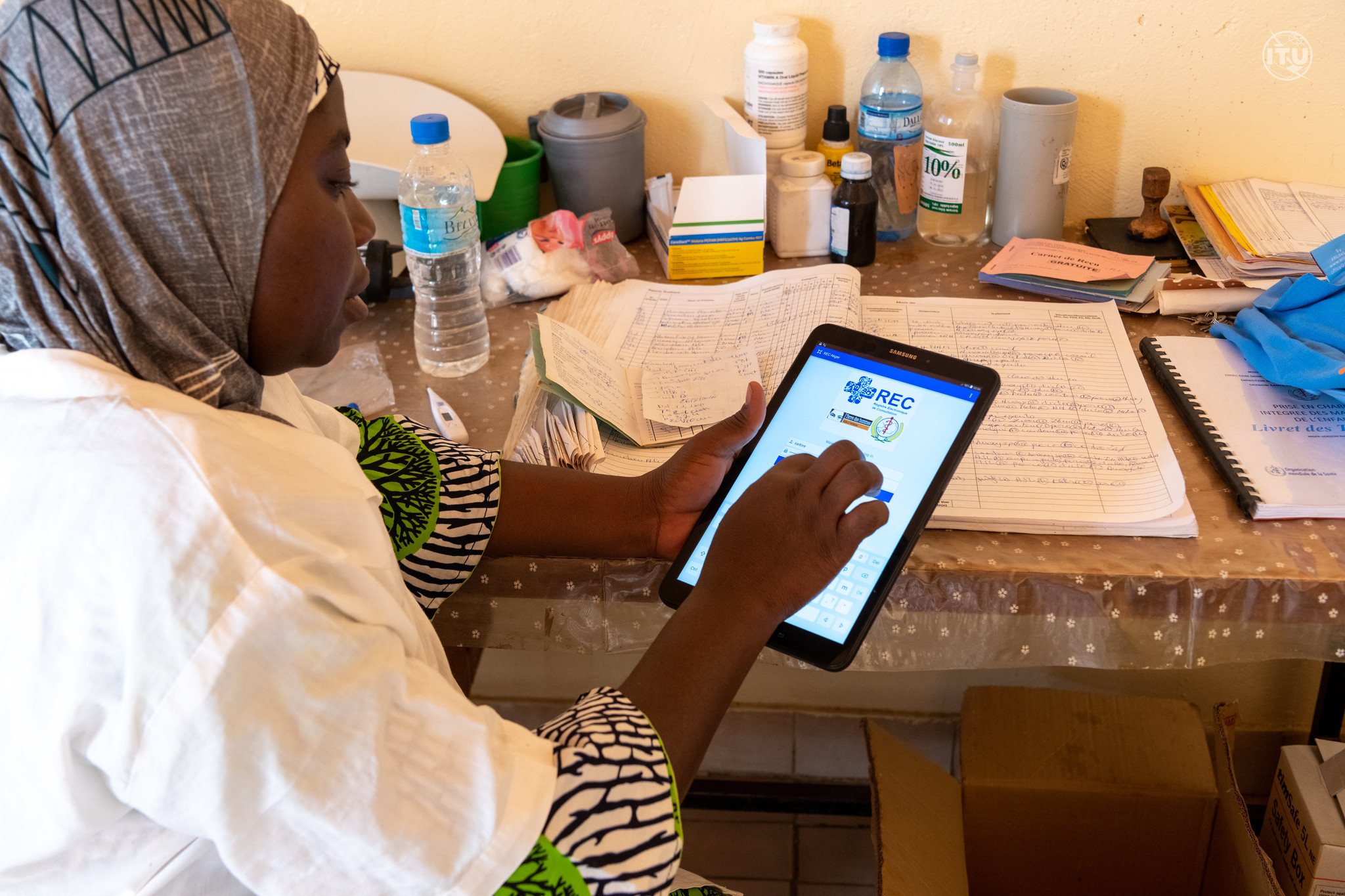 A woman is using a tablet.