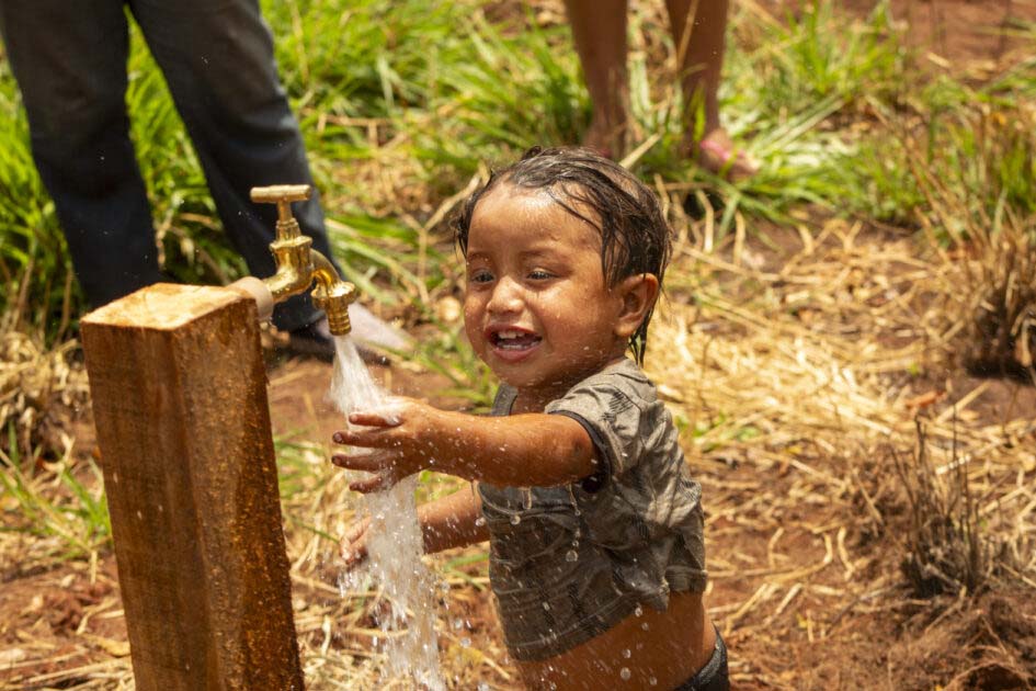 child at water tap