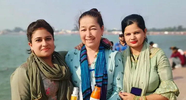 Rigzin (center) with her colleagues holding sea buckthorn-based products