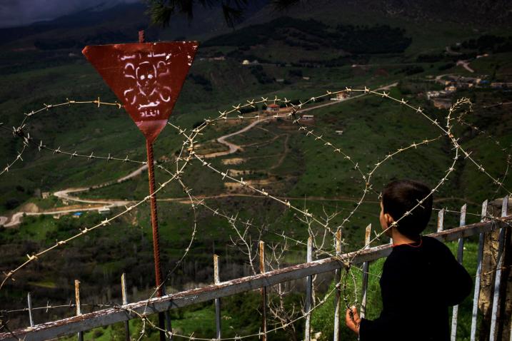 A boy stands near the barbed wire in an area contaminated by landmines in Dohuk Province, Iraq. Credit: UNHCR/Dominic Nahr