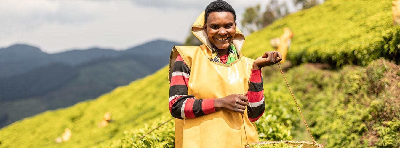 A woman smailing with tea in her basket. 