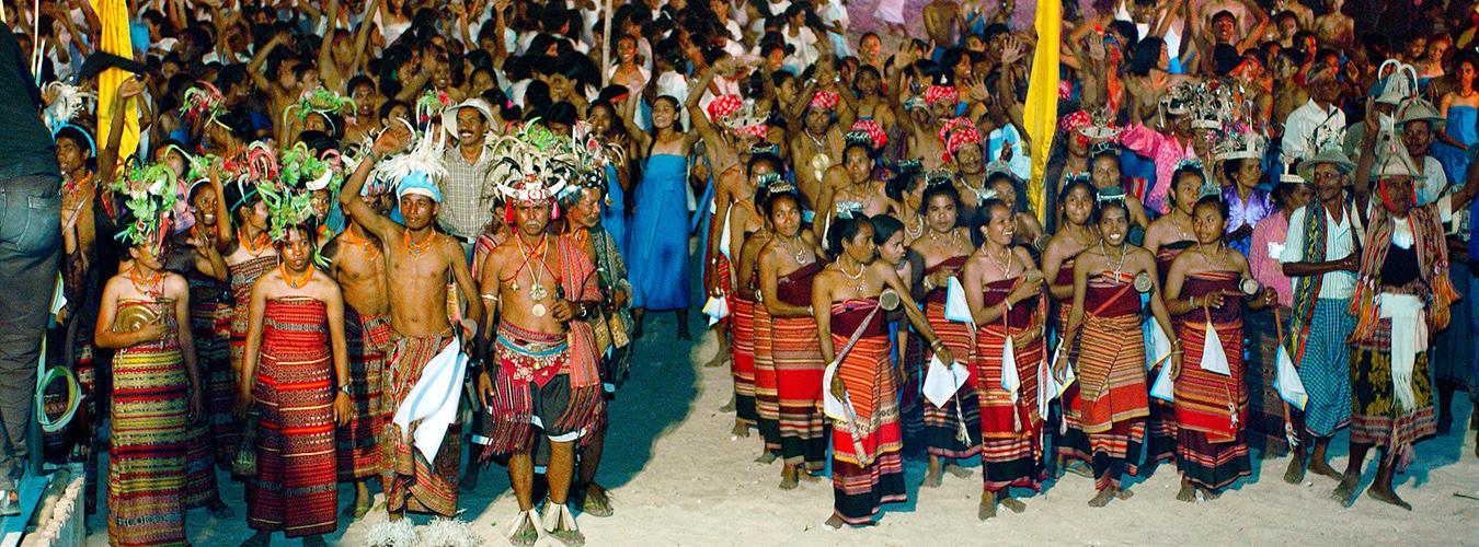 A large group of people in traditional dress cheering