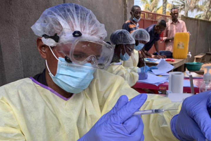 health worker with syringe