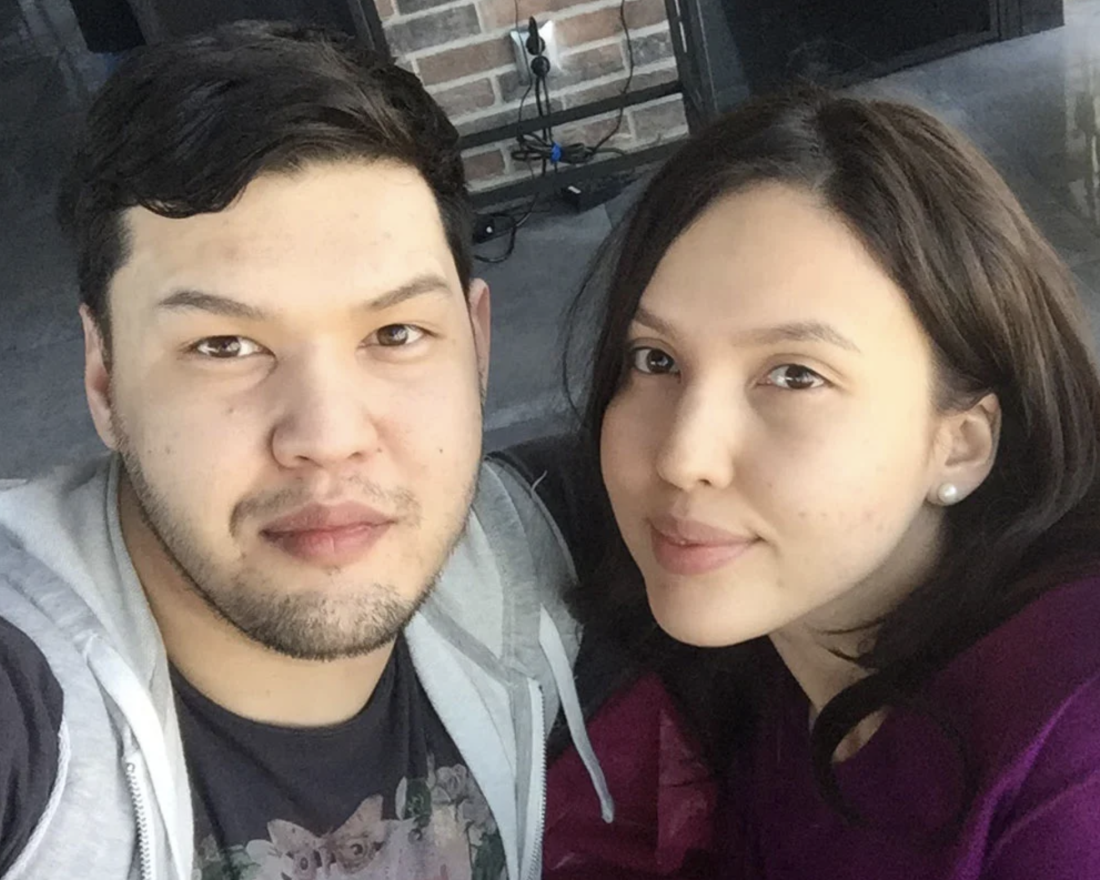 A photograph of a man and a woman looking into the camera