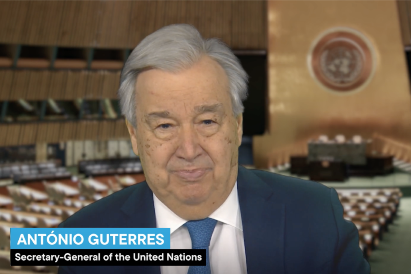 United Nations Secretary-General António Guterres stands in front of a background showing the General Assembly